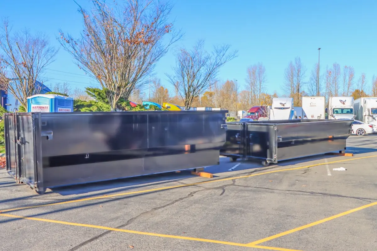 Professional dumpster rental service with roll-off container on residential driveway in Etowah